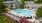a swimming pool in a courtyard with lounge chairs